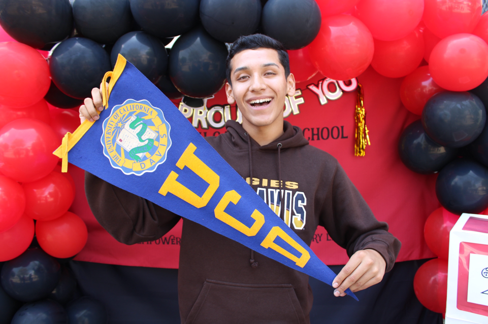 Male student holding his new university banner