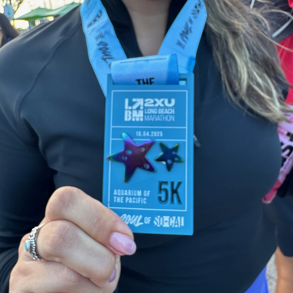 participant showing Long Beach Aquarium 5K badge