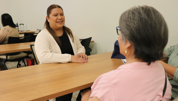 therapist sitting with a with a patient at a table