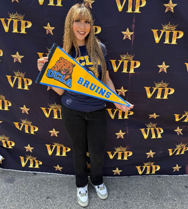 Student Idania showing off her university pennant